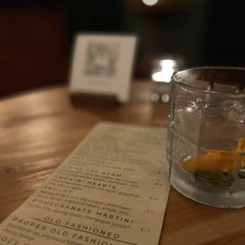 House Divided - a glass of water and a menu on a table - Cocktail Bars Near Me - Roseville, California