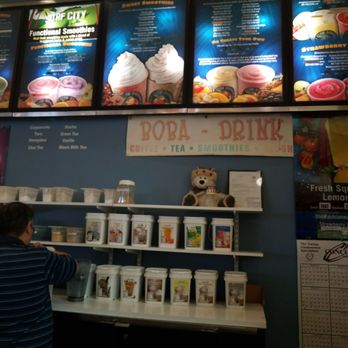Surf City Squeeze - a man standing in front of a menu - Juice Bars & Smoothies Near Me - Fresno, California Surf City Squeeze - a man standing in front of a menu - Juice Bars & Smoothies Near Me - Fresno, California