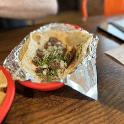 Fuego Tortilla Grill - Barbacoa taco! It comes undressed; my husband added onions and cilantro from the salsa bar.
