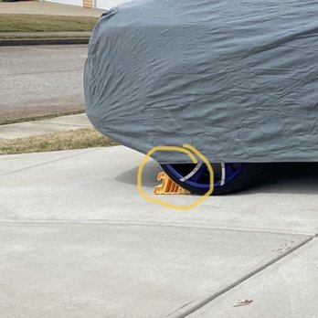 Tricon - Wheel chocks behind the rear tire circled - Real Estate Services Near Me Tricon - Wheel chocks behind the rear tire circled - Real Estate Services Near Me