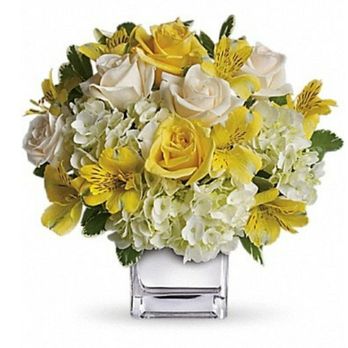 Augusta Florist - Feb 2021: Photo 4 of 4 (Website Photo of the Deluxe bouquet I ordered--  $87.95 subtotal) - A bouquet of yellow roses, white roses, and white hydrangeas arranged in a clear glass vase, with green leaves visible. - Florists Near Me - Augusta, Maine