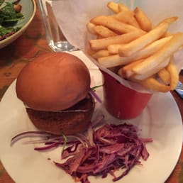 Falafel burger (butternut squash & nutmeg based) with red pepper & tomato chutney, rocket, and halloumi in a sourdough bun with fries.