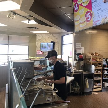 Tim Hortons - a man preparing food in a restaurant - Coffee & Tea Near Me - Southgate, Michigan