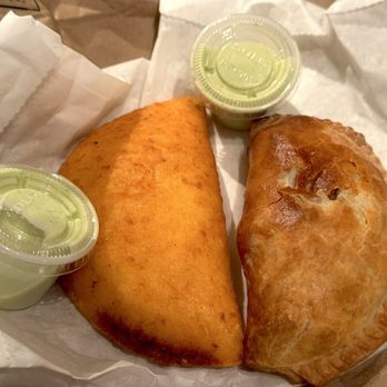 Titi’s - "Papa con queso" corn empanada (l) and Chopped Cheese puff pastry empanada (r). With dipping sauce - Sandwiches Near Me - New York, New York Titi’s - "Papa con queso" corn empanada (l) and Chopped Cheese puff pastry empanada (r). With dipping sauce - Sandwiches Near Me - New York, New York