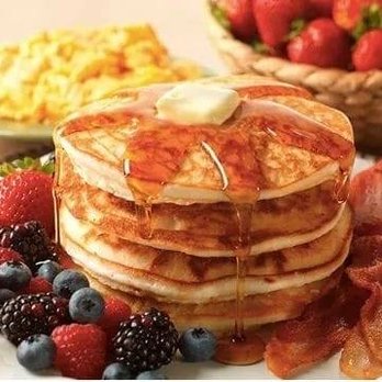 Hidden Kitchen - a stack of pancakes with syrup and fruit - Delis Near Me - Boston, Massachusetts