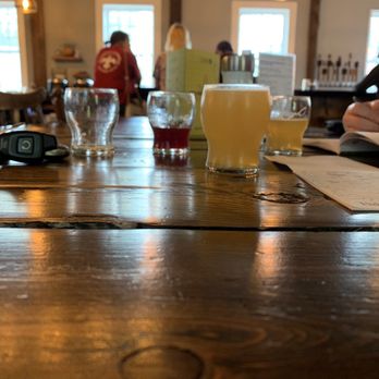 Post And Beam Brewing - a wooden table with glasses of beer - Breweries Near Me - Peterborough, New Hampshire Post And Beam Brewing - a wooden table with glasses of beer - Breweries Near Me - Peterborough, New Hampshire