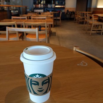 Starbucks - a starbucks cup on a table in a coffee shop - Coffee & Tea Near Me - Liverpool, New York Starbucks - a starbucks cup on a table in a coffee shop - Coffee & Tea Near Me - Liverpool, New York
