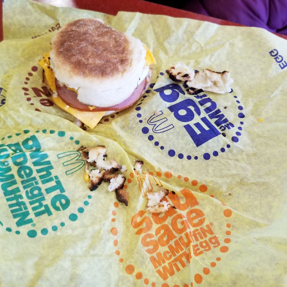 an english muffin sandwich on a plastic wrapper