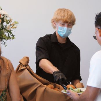 Englund's Catering - Professional staff serving at the buffet line. - Caterers Near Me