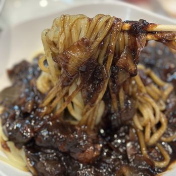H Mart - Plano - a plate of noodles and meat - Grocery Near Me - Plano, Texas