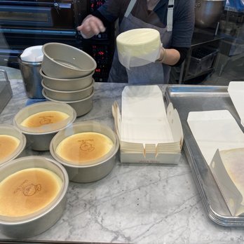 Uncle Tetsu - Worker taking cheesecake out of the baking pan. - Bakeries Near Me - Santa Clara, California