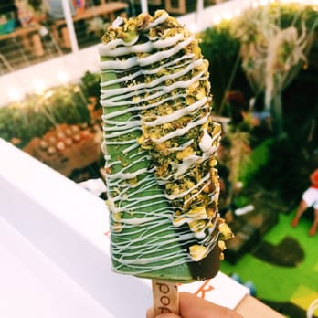 Popbar - Green tea, half dipped in milk chocolate, pistachios, and white chocolate drizzle - Desserts Near Me - Anaheim, California Popbar - Green tea, half dipped in milk chocolate, pistachios, and white chocolate drizzle - Desserts Near Me - Anaheim, California