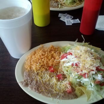 El Azteca Restaurant - Chilaquiles with shredded chicken, lettuce, tomato and sour cream. Side of rice and beans, with horchata to wash it down! - Mexican Near Me - Thornton, Colorado