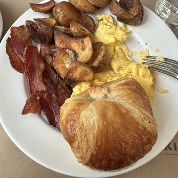 Kitchen No 324 - Thick bacon, potato crisps, scrambled eggs, and a buttery fluffy croissant. - New American Near Me - Oklahoma City, Oklahoma Kitchen No 324 - Thick bacon, potato crisps, scrambled eggs, and a buttery fluffy croissant. - New American Near Me - Oklahoma City, Oklahoma