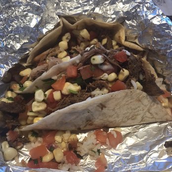Chipotle Mexican Grill - Cold dried out meat tacos - A taco filled with dried meat, corn, diced tomatoes, and herbs, wrapped in aluminum foil, served at a restaurant. - Mexican Near Me - Schenectady, New York