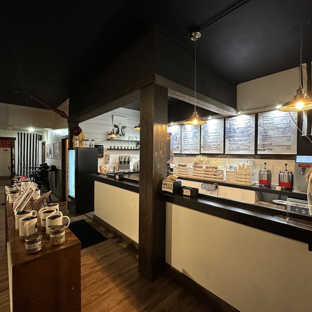 Sweet Peaks - a woman in a white apron preparing food in a restaurant - Ice Cream & Frozen Yogurt Near Me - Whitefish, Montana Sweet Peaks - a woman in a white apron preparing food in a restaurant - Ice Cream & Frozen Yogurt Near Me - Whitefish, Montana