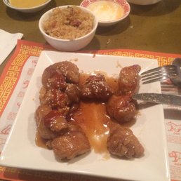 a plate of meatballs with sauce and rice a plate of meatballs with sauce and rice