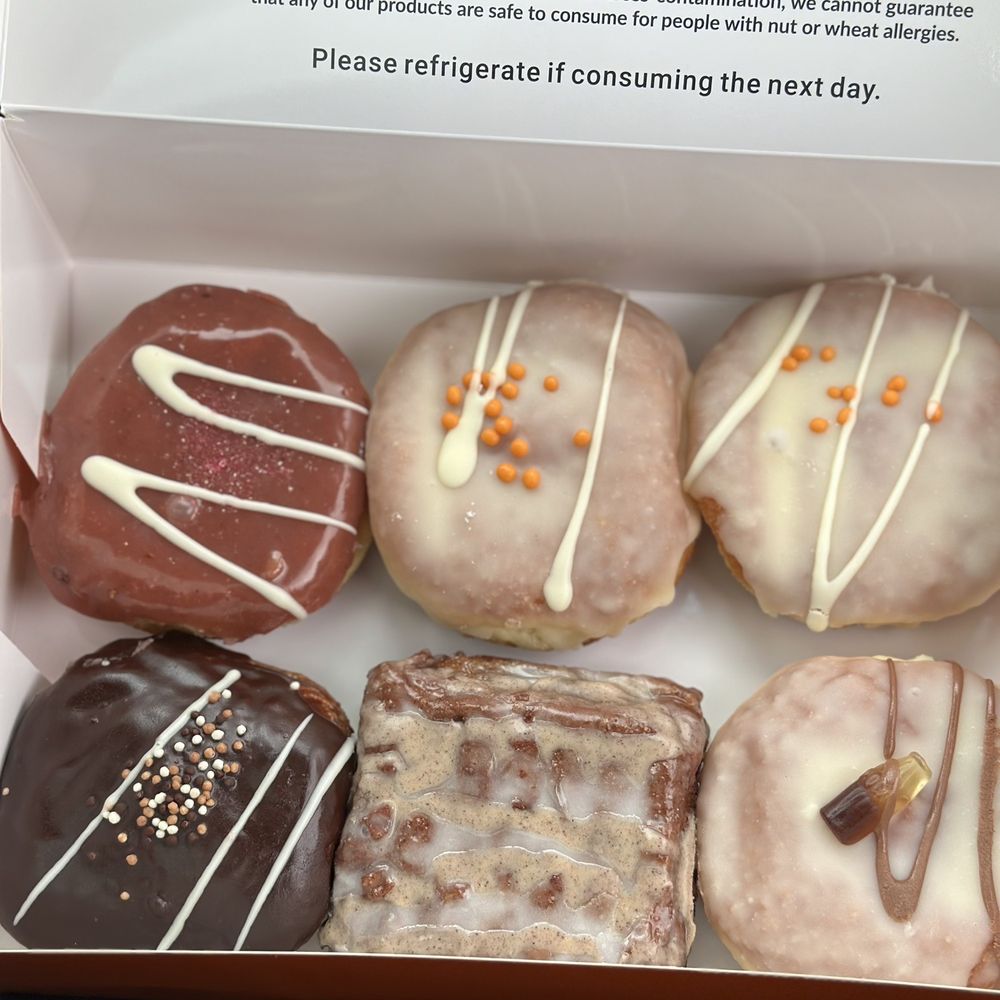 Ube, orange creamsicle, Boston cream, apple fritter and brûlée.