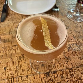 How to Cook a Wolf - I forget the name of this drink. Something "Sunrise..." a mocktail with black tea and spiced apple. Very, very good. - Italian Near Me - Seattle, Washington