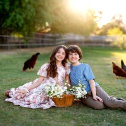 Madison Grey Photography - A warm outdoor sibling portrait at golden hour featuring two children together in a relaxed setting, photographed by Madison Grey.