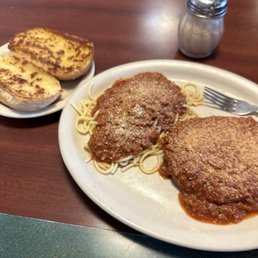 Veal Parmesan, spaghetti and garlic bread. Veal Parmesan, spaghetti and garlic bread.