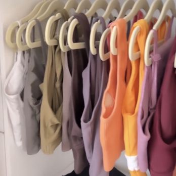 Neatly - Workout clothes hung in matching closet hangers. Everything is color coordinated. - Home Organization Near Me Neatly - Workout clothes hung in matching closet hangers. Everything is color coordinated. - Home Organization Near Me