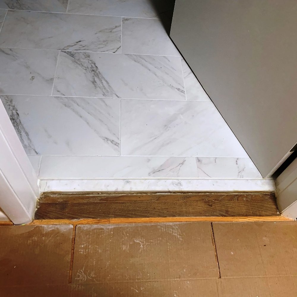 Triangle Remodeling Service - Used brown wood for threshold next to regular light oak flooring - General Contractors Near Me - Chapel Hill, North Carolina Triangle Remodeling Service - Used brown wood for threshold next to regular light oak flooring - General Contractors Near Me - Chapel Hill, North Carolina