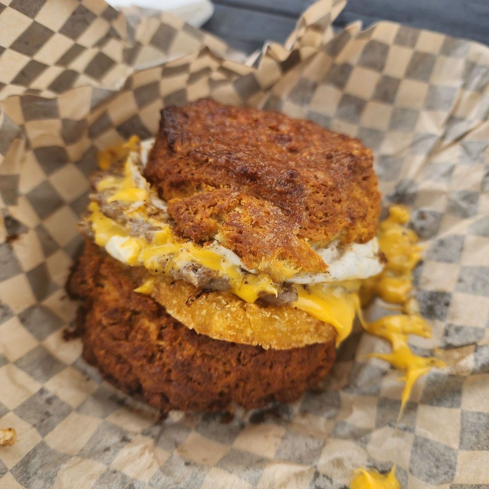 Biscuit buns with an egg, two smash patties, cheese and hashbrown patty in the middle. Biscuit buns with an egg, two smash patties, cheese and hashbrown patty in the middle.