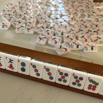 Mahj with Molly - Mah Jongg tiles (with fish on the backs) on a rack at the beginning of a game with friends! - Team Building Activities Near Me Mahj with Molly - Mah Jongg tiles (with fish on the backs) on a rack at the beginning of a game with friends! - Team Building Activities Near Me