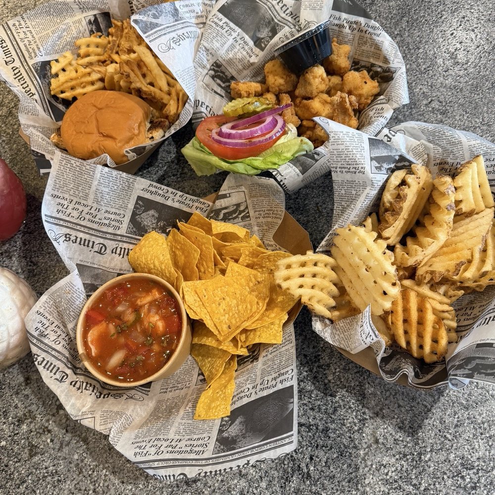Ceviche with chips, waffle fries, fish sandwich, and fish bites