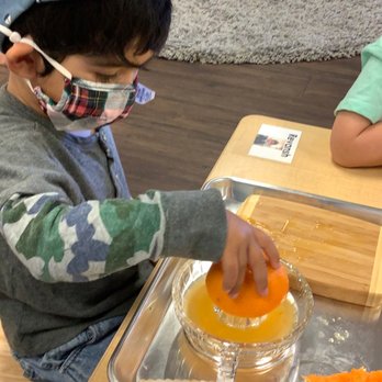 Guidepost Montessori at Folsom - Juicing a citrus fruit - Elementary Schools Near Me - Folsom, California Guidepost Montessori at Folsom - Juicing a citrus fruit - Elementary Schools Near Me - Folsom, California