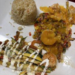 Grilled tilapia with mango salsa, grilled veggies, and rice. Grilled tilapia with mango salsa, grilled veggies, and rice.
