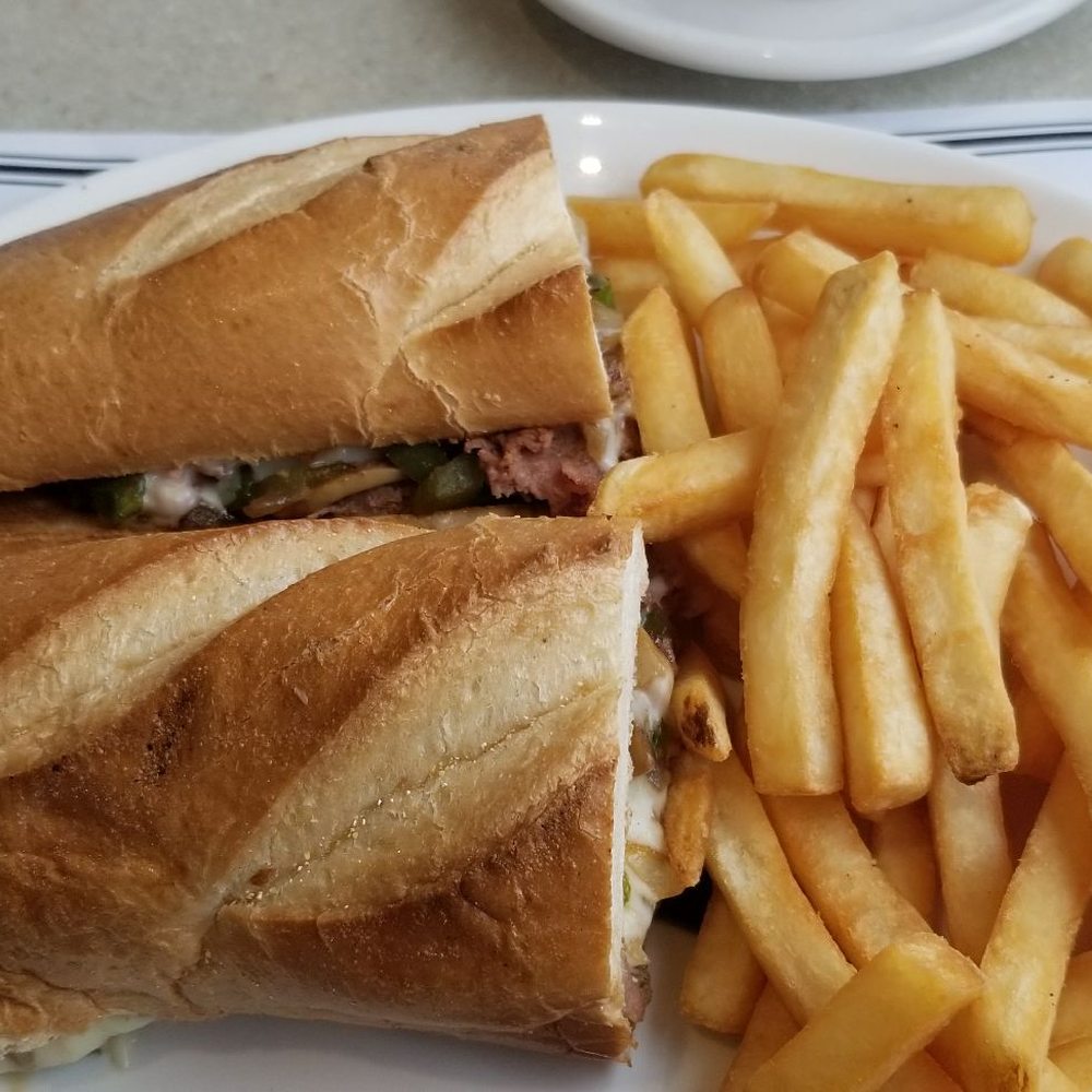 Philly steak and cheese grinder with crispy fries Philly steak and cheese grinder with crispy fries