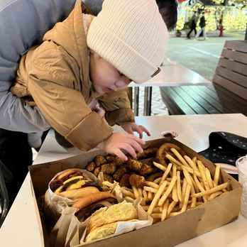 Joe's Burgers - Helping himself to some fries. - Burgers Near Me - Tigard, Oregon Joe's Burgers - Helping himself to some fries. - Burgers Near Me - Tigard, Oregon