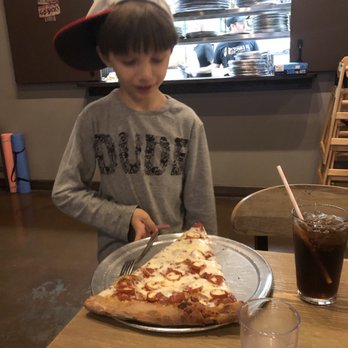 Zombie Bob's Pizza - My older son wondering how he's going to manage this slice! - Pizza Near Me - Charleston, South Carolina