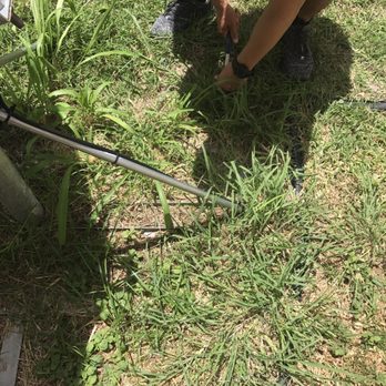 Direct TV - Trying to pry the spike from the ground just to loosen the base from the ground. - Television Service Providers Near Me - Honolulu, Hawaii