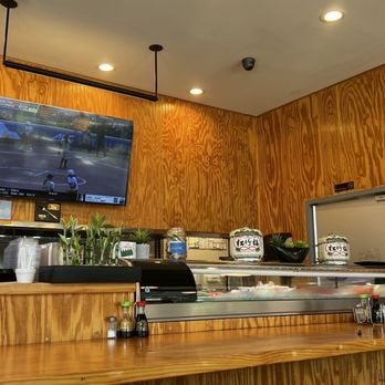 Bachi - a restaurant counter with a television on the wall - Sushi Bars Near Me - Charlotte, North Carolina