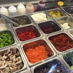 a variety of salads and condiments a variety of salads and condiments