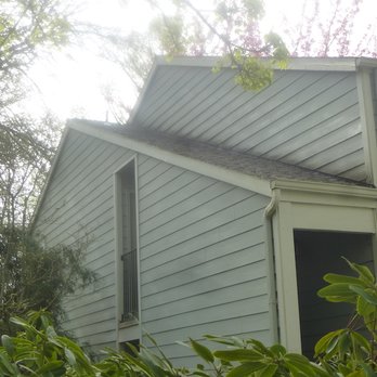 The Gutter Wizard - Next building over, same problem, Roof moss and siding above left undone. - Gutter Services Near Me