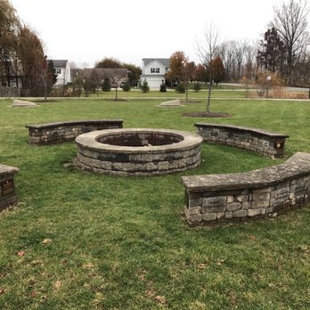 Simon Moon Park - Concrete fire pit with concrete cornhole game in the background - Parks Near Me - Westfield, Indiana Simon Moon Park - Concrete fire pit with concrete cornhole game in the background - Parks Near Me - Westfield, Indiana