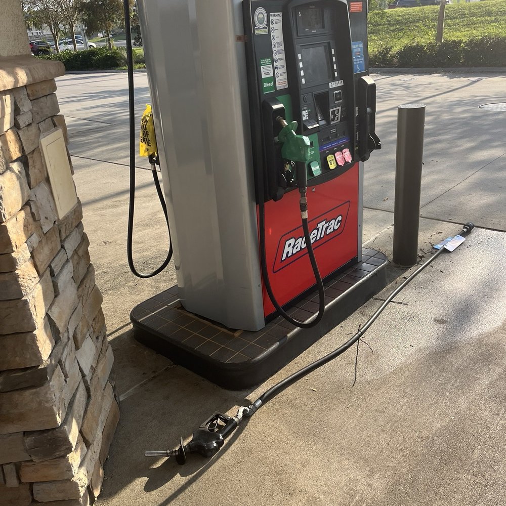 Gas pump hose falling from pump and spraying gas all over Gas pump hose falling from pump and spraying gas all over