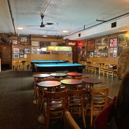 a pool table and chairs a pool table and chairs