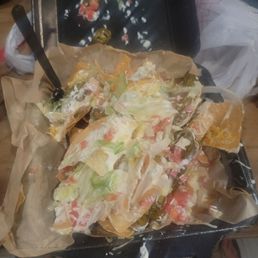 Cold shitty chicken nachos were they forgot the chicken. Cold shitty chicken nachos were they forgot the chicken.