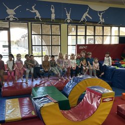 Kids listening to teachers explain the obstacle course.
