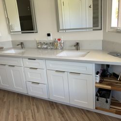 CAA Hawaii Cabinet - Upstairs bathroom cabinets, sinks, and countertop.
