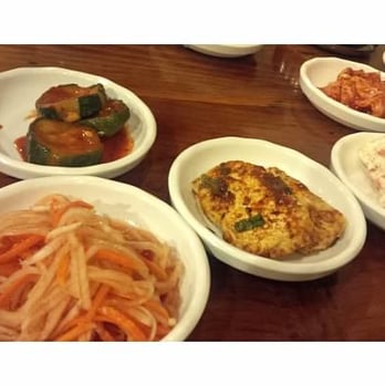 Oegadgib - Banchans - moo and carrot namool (pickled daikon radish and carrot; bottom left), cucumber, dooboo jorim, potato salad, & kimchi - Korean Near Me - Annandale, Virginia