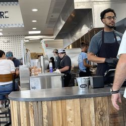 Al's Burger Shack - Small open kitchen area. I'm a bit disturbed to see the can of cleaner on top of the beer fridge. That's a health violation.
