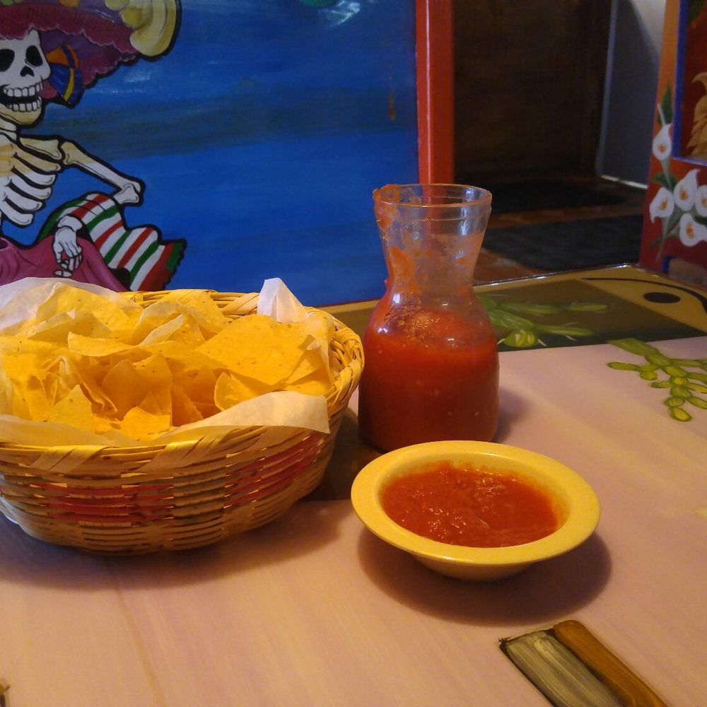 a basket of chips and a glass of ketchup a basket of chips and a glass of ketchup
