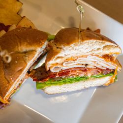 Main Street Cafe - The Big Poppy - Turkey, bacon, cheddar, tomato, greens, poppy seed dressing on a pretzel roll.