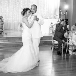 a bride and groom sharing a first dance a bride and groom sharing a first dance